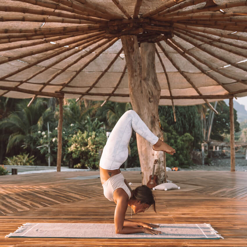 woman doing yoga at beachside Yoga Shala