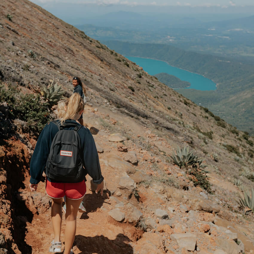 women hiking atop volcano