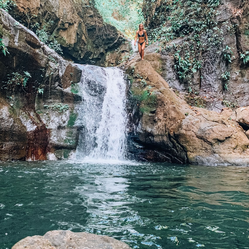woman at top of waterfall