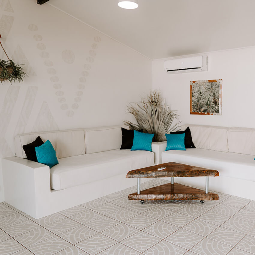 Sectional sofa in sitting area of Private Jungle Bungalow at the women's Phoenix Retreat in El Salvador